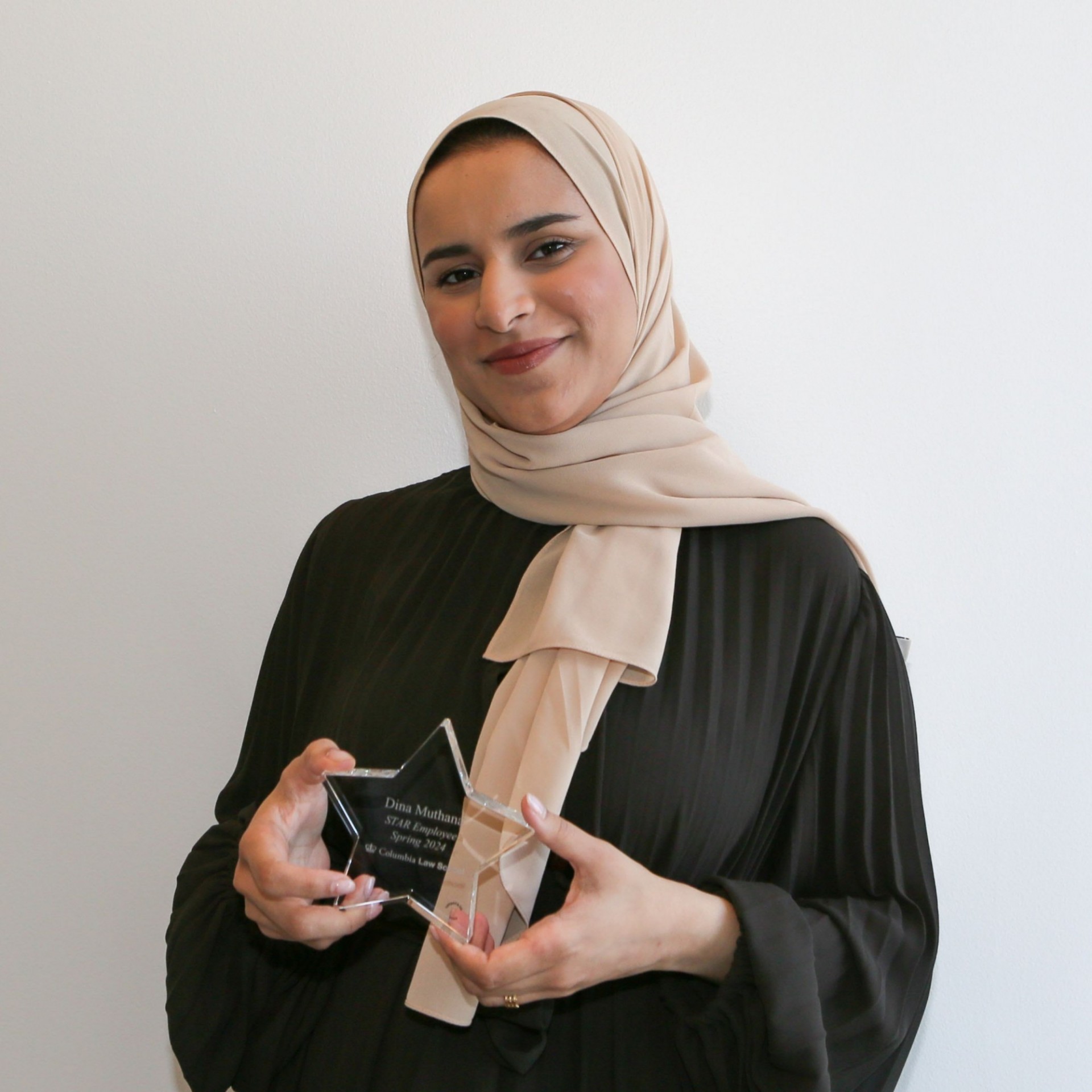 Pictured: Dina Muthana holding her STAR Award. 