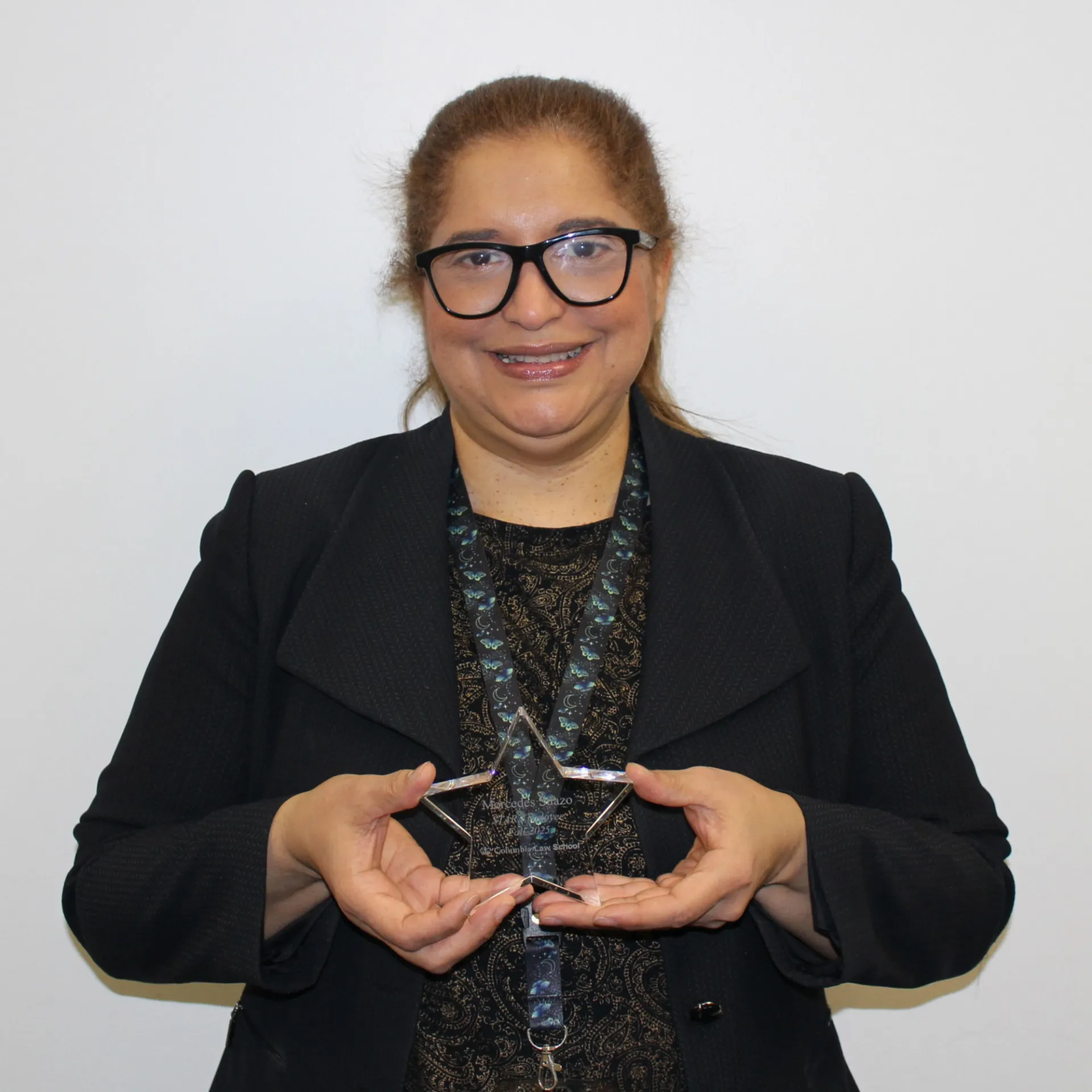 Mercedes Suazo holding her STAR Award.