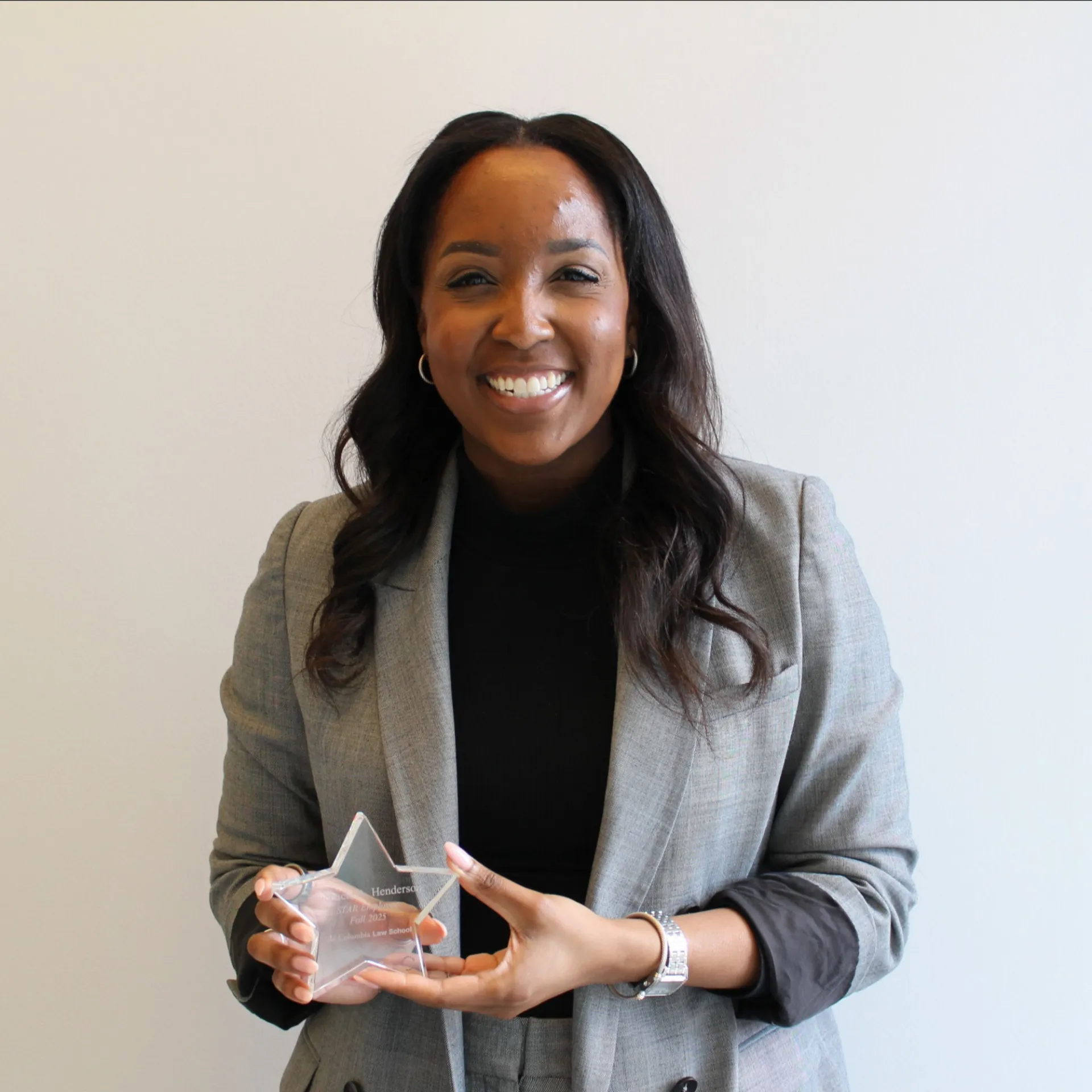 Rachaele Henderson holding her STAR Award. 